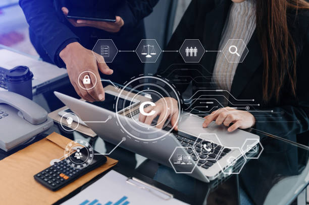 istock Copyright or patent concept, Business team analyzing data and using smart phone and tablet with virtual screen copyright icon trademark license, Creation ownership against piracy. 1455959044