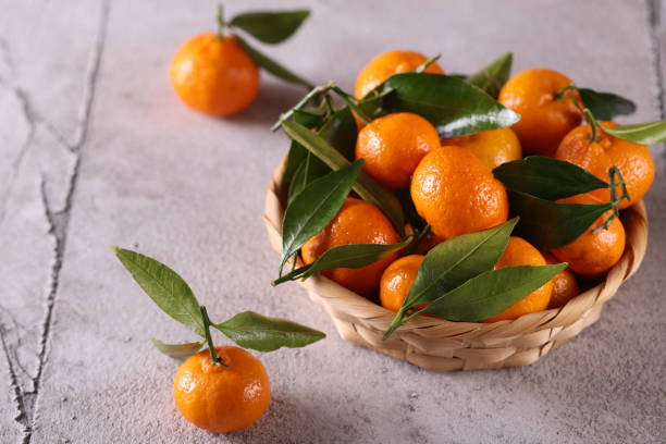 istock natural organic tangerines with green leaves 1455959085