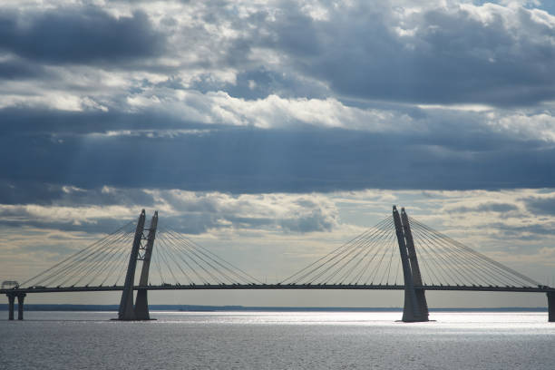 istock a cable-stayed bridge across the bay and a beautiful sky in the clouds through which the sun breaks through 1455962860