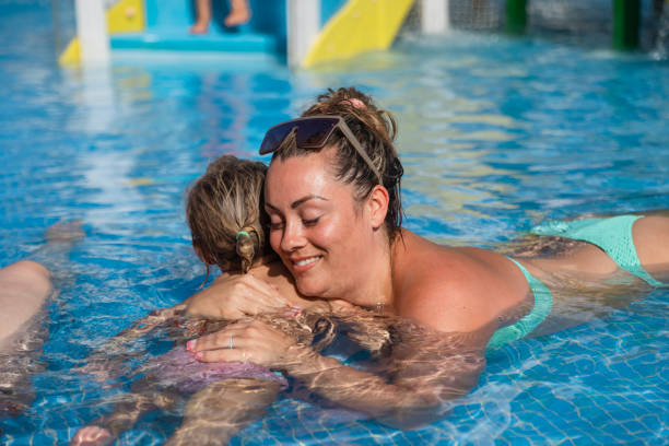 istock Hugging in the Swimming Pool 1455962893