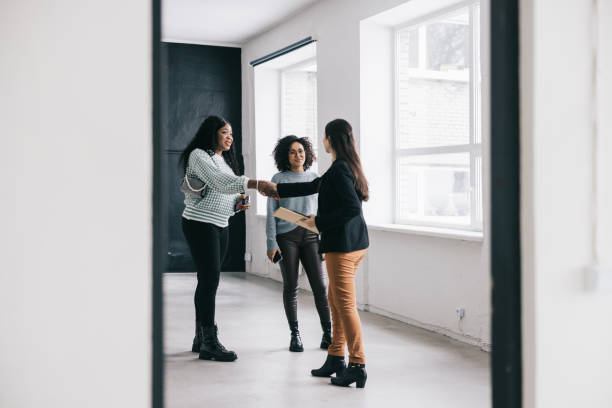 istock Real Estate Agent greeting business clients with a handshake 1455963361