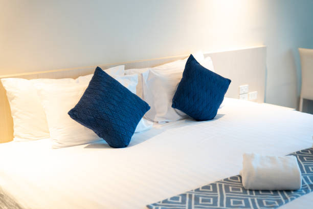 istock Stack of clean towels on bed in bedroom. 1455963709