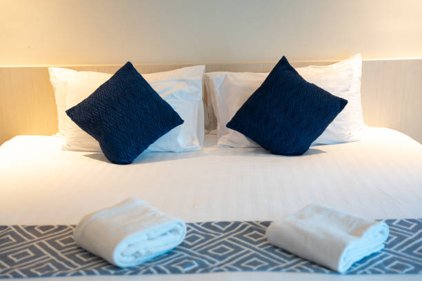 istock Stack of clean towels on bed in bedroom. 1455964338