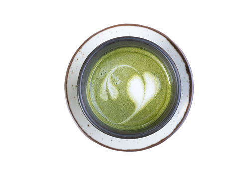 Flat lay of green tea latte art in ceramic cup , isolated on white background with clipping path