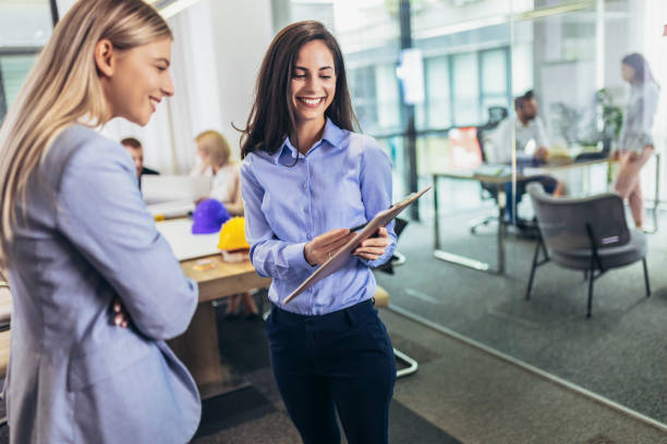 istock Creative female executives meeting in an office and smiling. 1455964979