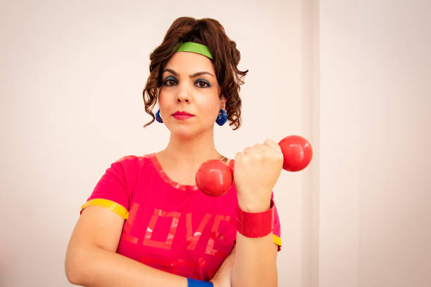istock 80s woman portrait holding dumbbell 1455965043