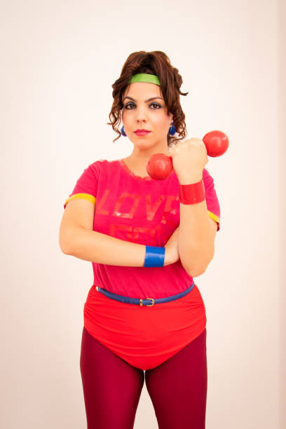 istock 80s woman portrait holding dumbbell 1455965044