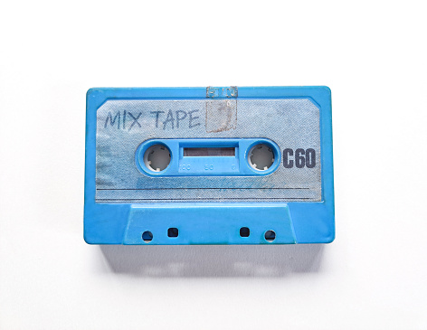 Blue cassette tape with the words mix tape hand written on the label.