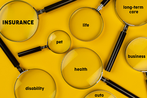 Insurance planning. Magnifiers on yellow background.