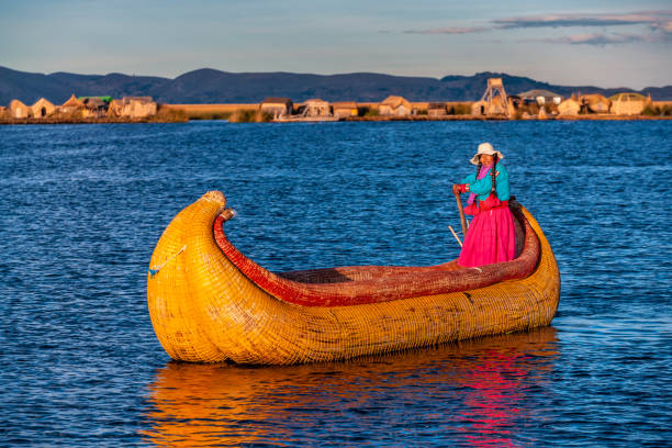 istock Peruvian woman sailing between Uros floating islands, Lake Tititcaca 1455965913