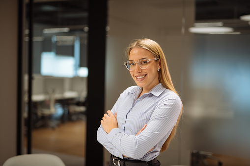 Female employee dressed in smart businesswear working in office