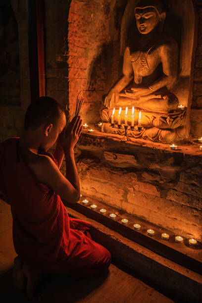 istock Novice buddhist monks contemplating inside temple, Myanmar 1455966098