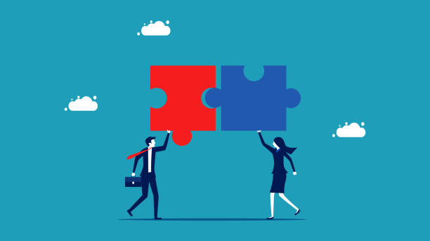 istock Help each other in business. Male and female employees work together to complete a jigsaw puzzle 1455966424
