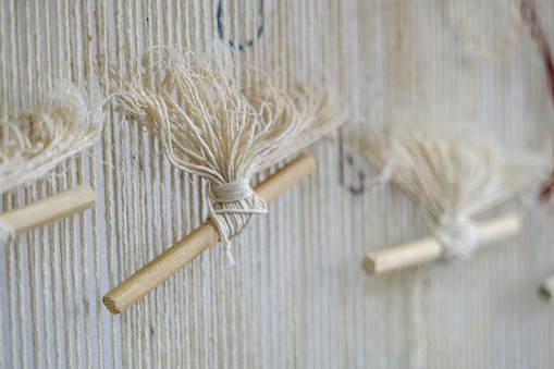 Close-up shot of wool yarns on carpet weaving loom