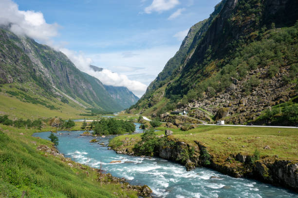 istock Norwegian valley with mountain ranges and flowing turquoise water 1455966726