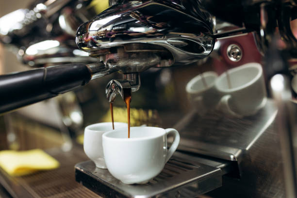 istock Black coffee being prepared from coffee machine into glass cup. Professional coffee brewing, hot coffee. 1455967712