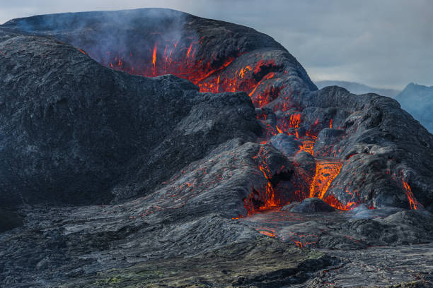 istock Volcanic crater with a mouth with some lava 1455967799