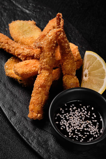 istock Tempura shrimp and Tempura vegetables on black concrete background 1455969573