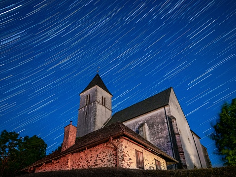 A low-angle shot of a church at the summit of Magdalensberg in Carinthia, under the sky full of stars