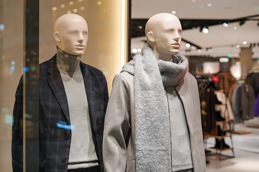 Male mannequins in a shop. Sale of clothes , suit , sweaters for men