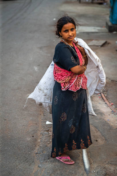 istock Young woman collecting plastic on a street 1455978037