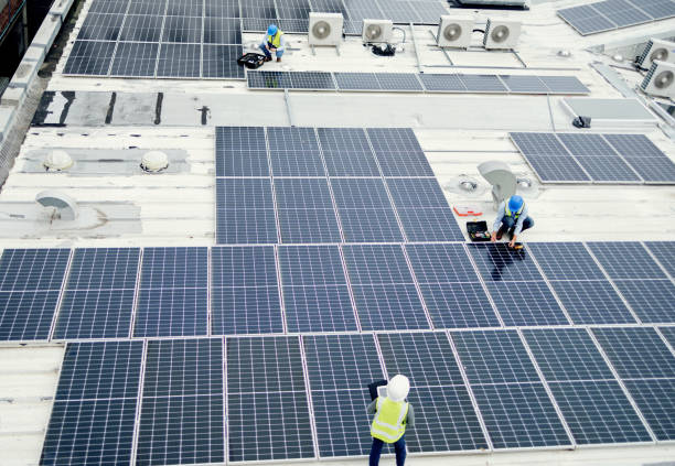istock Grid, solar energy and roof construction engineering people working on renewable energy installation. Sustainability, solar panel and professional contractor team work on building rooftop. 1455979205