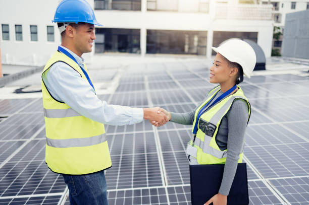 istock Solar energy, solar panel worker and renewable energy handshake electricity deal of sustainability, power plant development and innovation. Clean energy, sustainable technology and green construction 1455979240