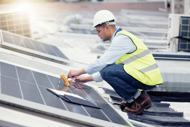 istock Solar panel, engineer and electrician working, upgrade and maintenance construction on building roof outdoor. Solar energy, renewable energy and engineering worker or technician fix solar panels 1455979254