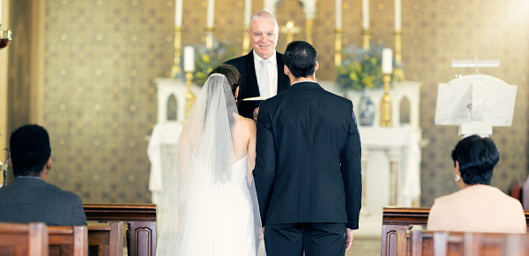 Couple, wedding and priest with commitment, love and marriage ceremony in church service together. Man, woman and pastor with trust, celebration and christian marry event in a chapel or spiritual