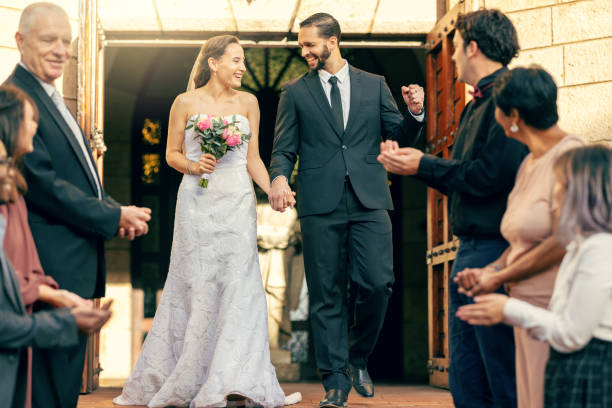 istock Wedding, man and woman celebrating their love by church after a commitment ceremony with guests. Marriage, married and loving couple in romantic celebration with husband and wife for romance 1455979426