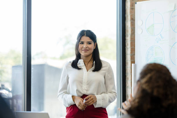 istock During presentation, female employee listens uncertainly to question from boss 1455979624