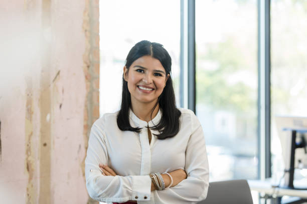 istock Standing in office, female entrepreneur smiles for camera 1455980113