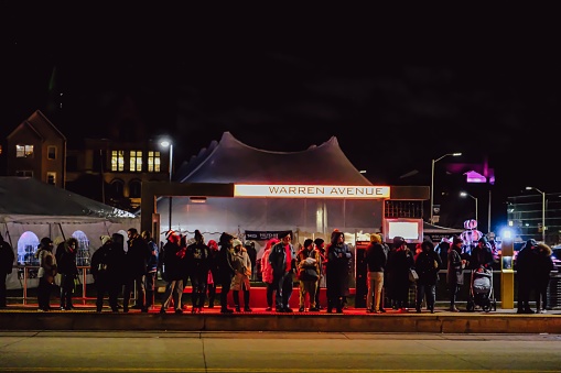 Detroit, United States – December 03, 2022: A busy QLine queue at Warren Avenue stop, on Noel night 2022 in Detroit Michigan, US