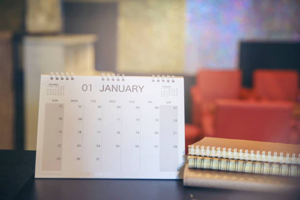 istock 2023 Calendar desk place on table. Desktop Calender for Planner to plan agenda, timetable, appointment, organization, management each date, month, and year on wooden office table.Calendar Concept. 1455982605