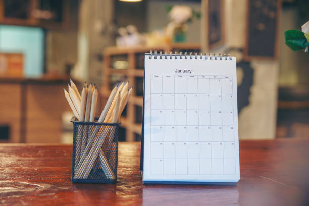 istock 2023 Calendar desk place on table. Desktop Calender for Planner to plan agenda, timetable, appointment, organization, management each date, month, and year on wooden office table.Calendar Concept. 1455982616