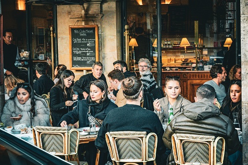 Paris, France – November 13, 2022: The people sitting outside a cafe in Paris, France