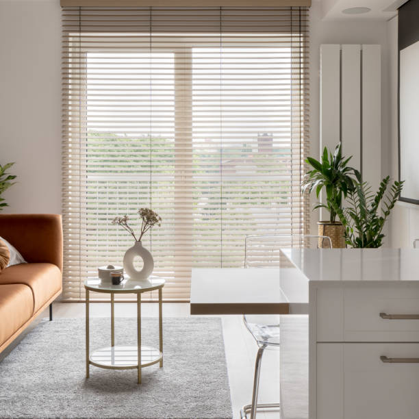 istock Big window with wooden blinds in elegant studio apartment 1455983319
