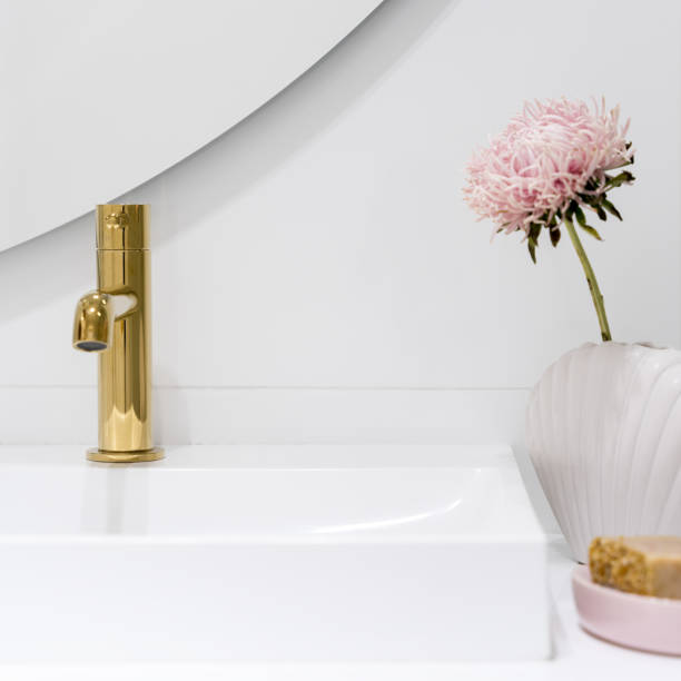 istock Golden tap in bathroom washbasin, close-up 1455983346