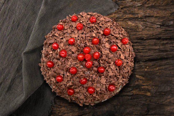 istock Chocolate cake with cherries on wooden background 1455983479