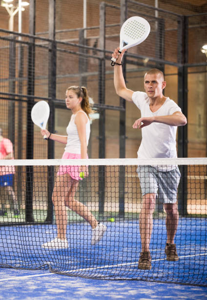 istock Male player ready to hits the ball while playing padel 1455983494