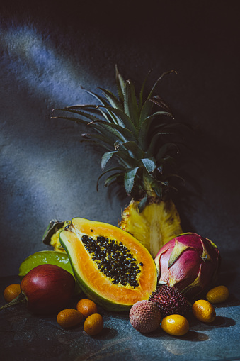 Tropical fruits assortment, dark photography. Still life photography of fresh fruits.