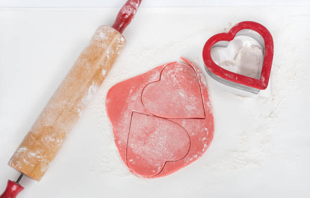 istock Pink Cookie Dough Hearts with Heart Cookie Cutter and Rolling Pin 1455985045