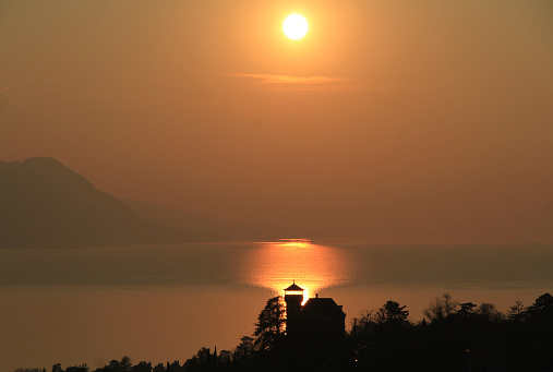 These beautiful sunset views are from Montreux which is at the northeast shore of the lake. The twilight is reflected on the water The evening sky becoming golden and reddish.