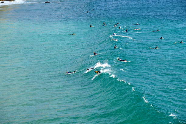 Zavial, Portugal, 09-19-2020\nSurfers in nice waves at Zavial beach (Praia do Zavial)  at the Algarve coast