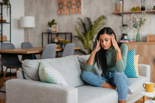 istock Young Woman Having A Headache At Home 1455992547
