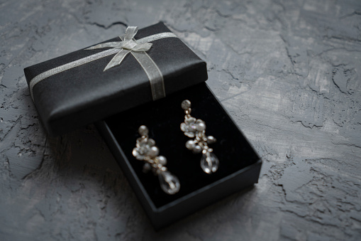 Earring in gift box with ribbon