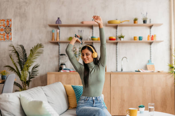 istock Young Woman Singing And Dancing At Home 1455993708