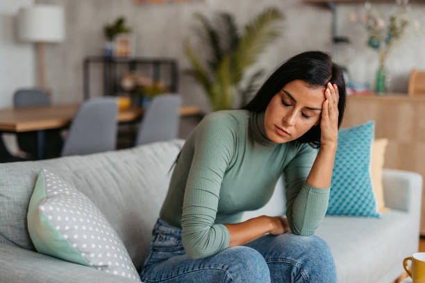 istock Young Woman Having A Headache At Home 1455993757