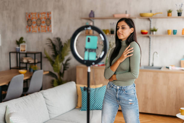 istock Young Woman Taking Selfies Using Ring Light At Home 1455994124