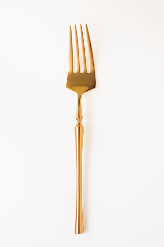 Golden fork isolated on white background.Studio shot.